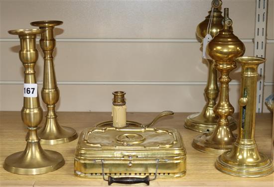 Seven brass items including candlesticks and handwarmer, etc